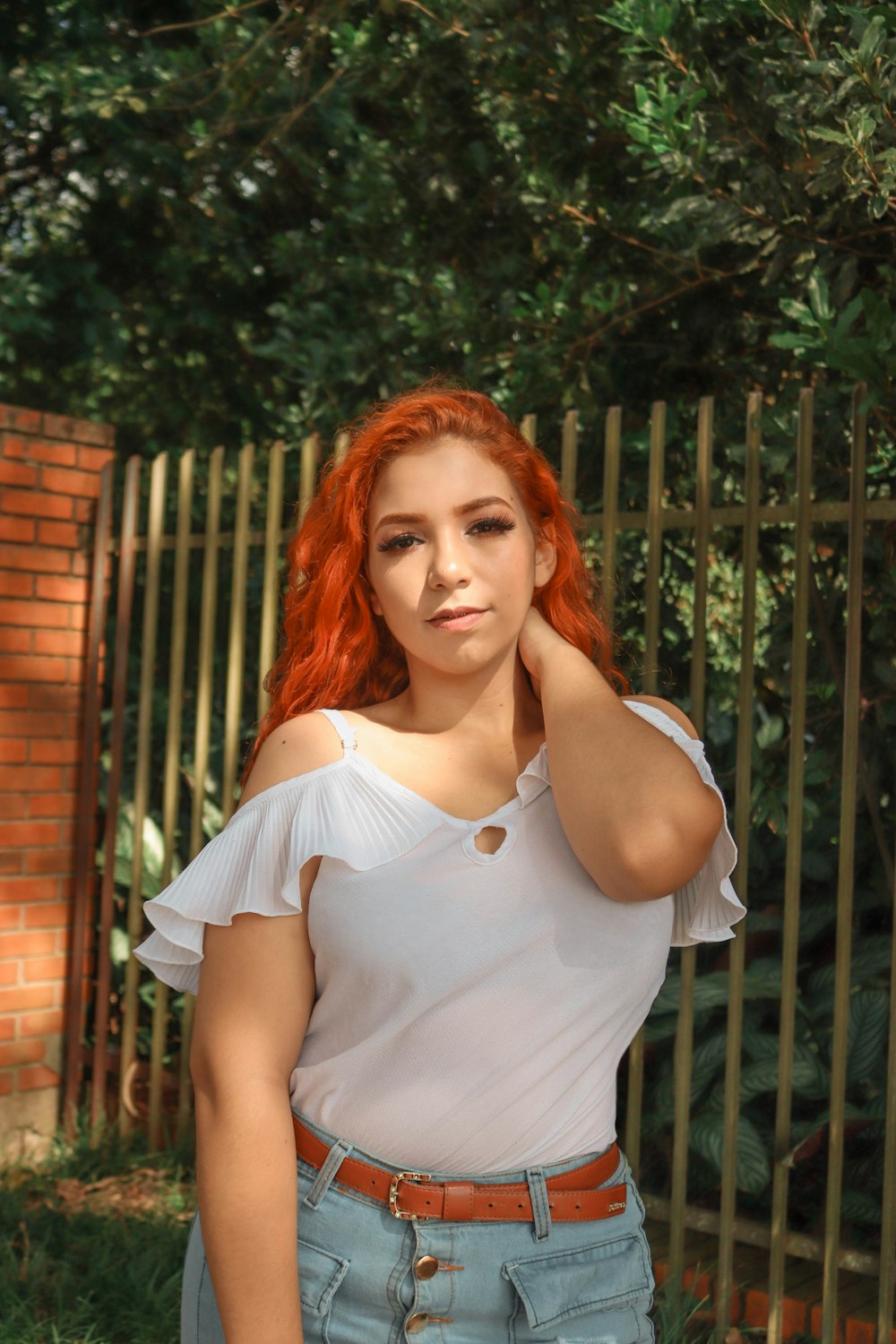 a woman with red hair is posing for a picture