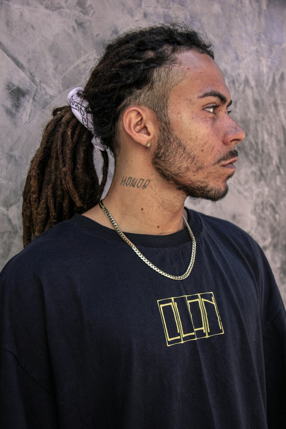 a man with dreadlocks wearing a black shirt