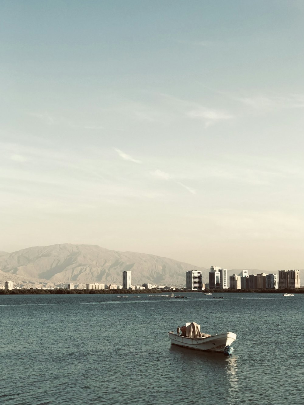 a small boat floating on top of a large body of water