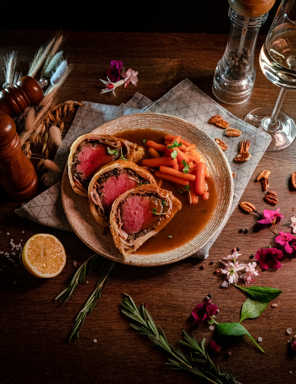 a plate of food with carrots, meat and gravy