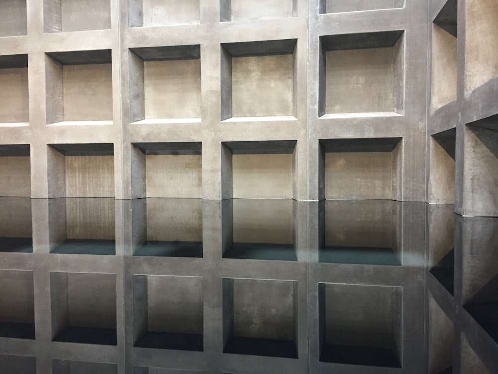 a wall made out of concrete blocks with water in the middle