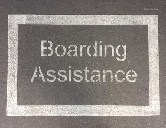 a sign that reads boarding assistance