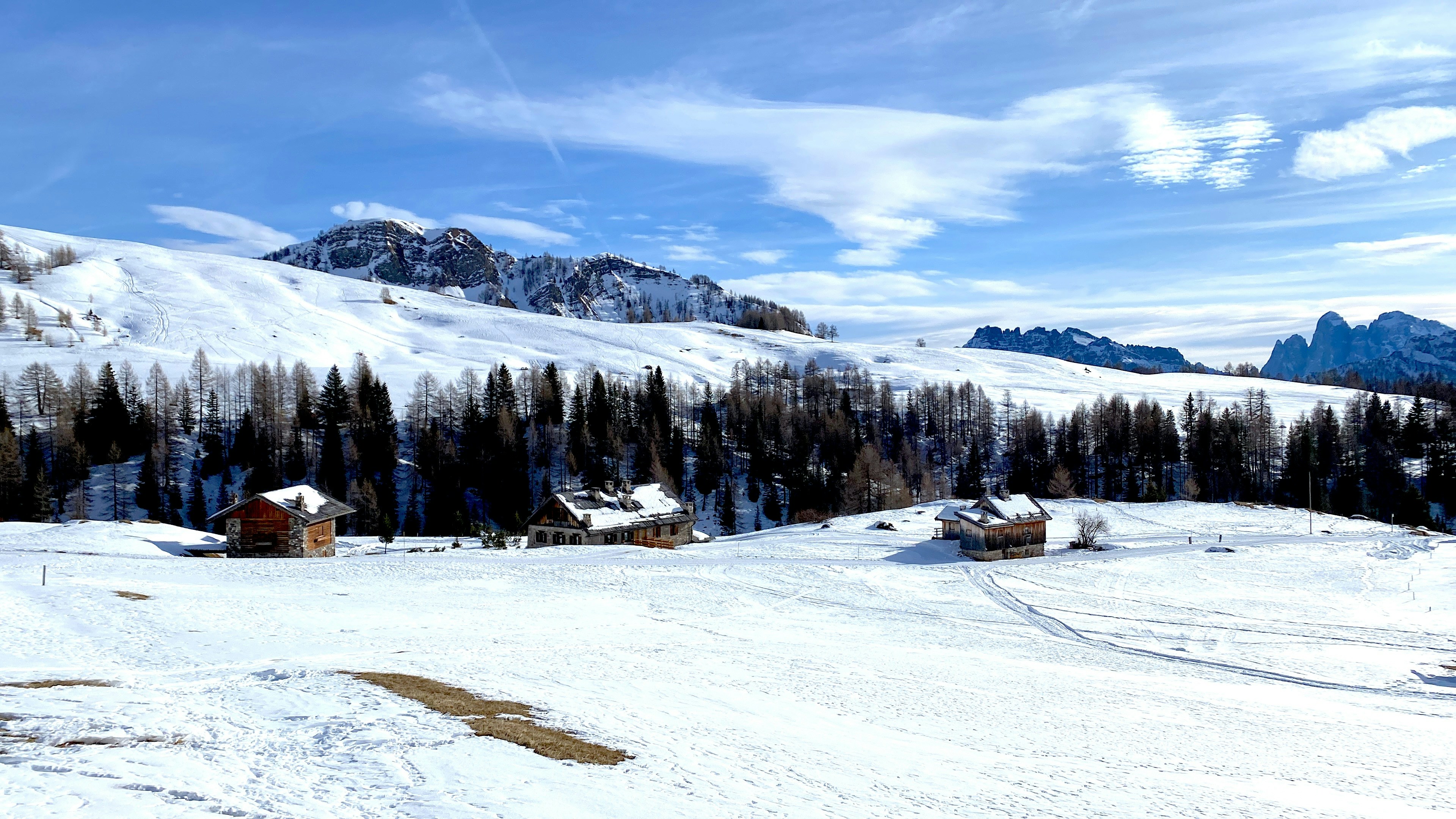 a snowy landscape with a mountain in the background