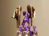 a group of purple and gold hairbrushes sitting on top of each other