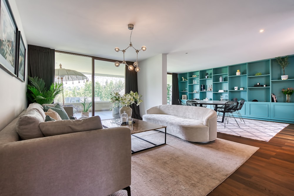 a living room filled with furniture and a large window