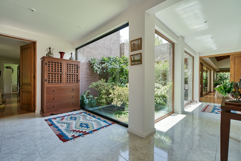 a room with a rug on the floor and a large window