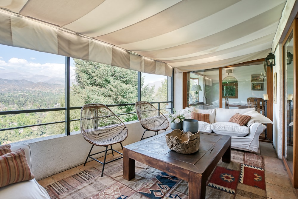 a living room filled with furniture and a large window