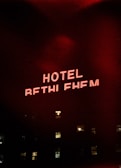a red neon sign that reads hotel rethifium