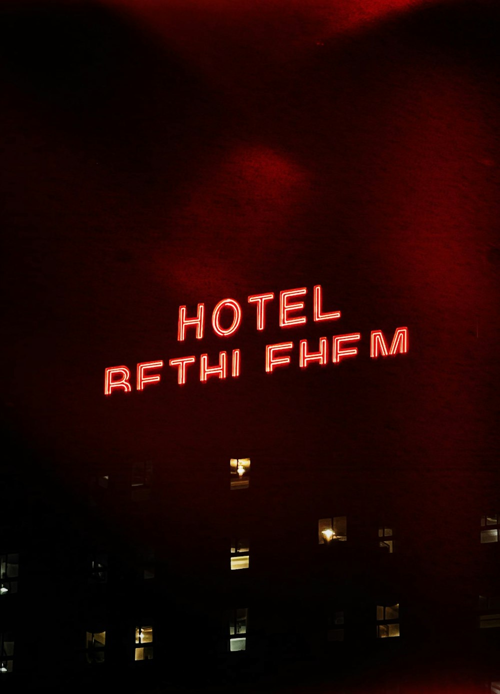 a red neon sign that reads hotel rethifium