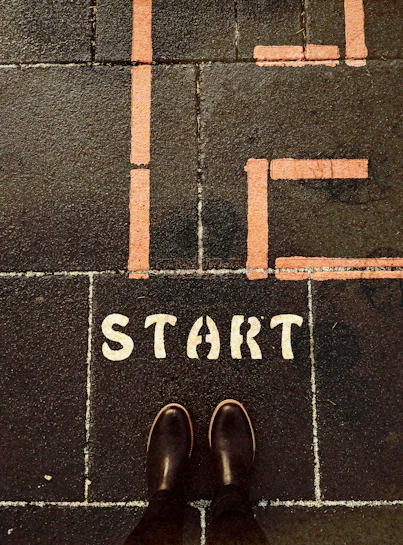 a person standing on a sidewalk with the words life start painted on it