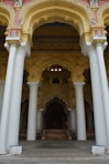 a large building with columns and a clock on the wall