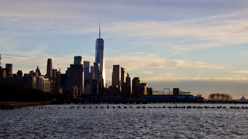 a large body of water with a city in the background