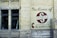 A brick wall with a large sign painted on it displaying the name 'Silco Industries Ltd.' along with an arrow pointing towards the entrance at 70 Arthur St. The wall is part of an older building with two large windows and visible pipes, adding an industrial vibe.