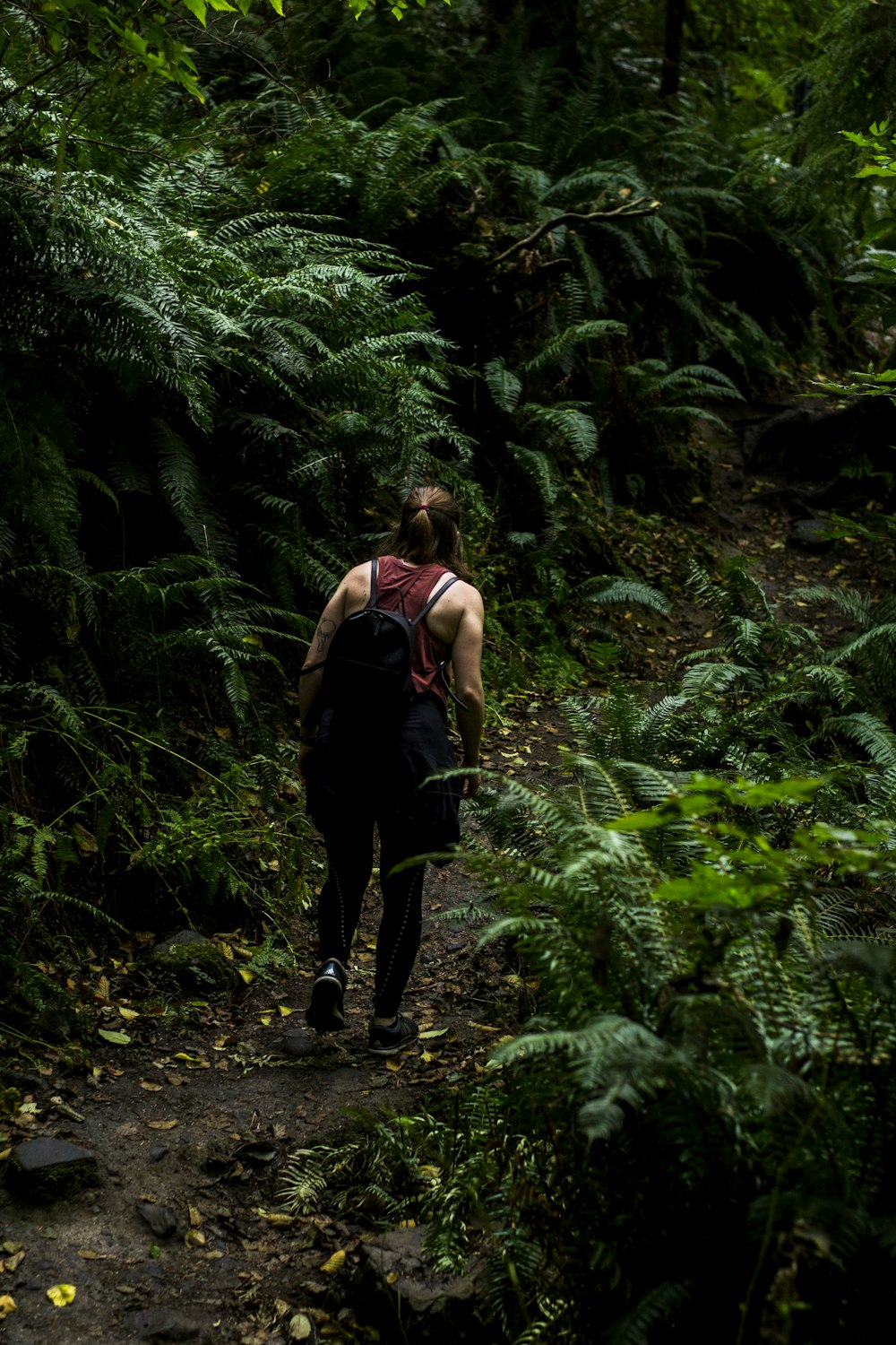 a man with a backpack walking through a forest