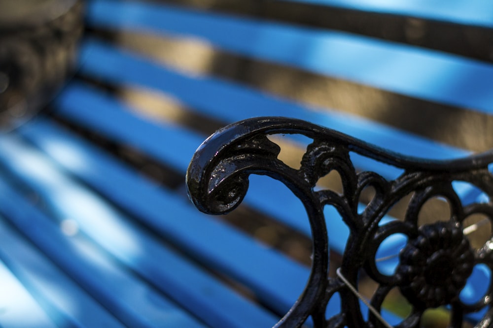 a close up of a metal and wood bench