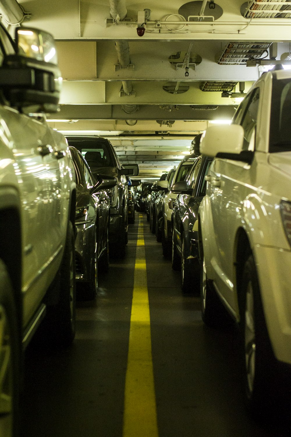 a line of cars parked in a parking garage