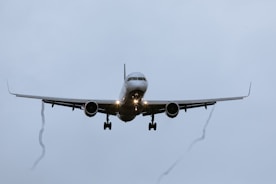 a large jetliner flying through a cloudy sky