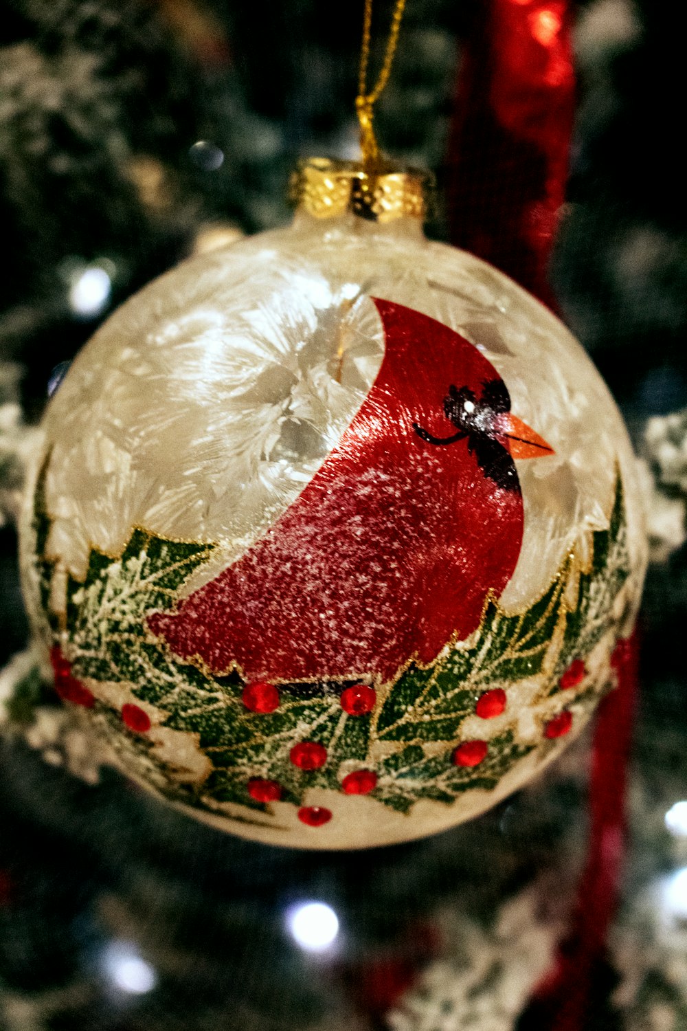 a glass ornament hanging from a christmas tree