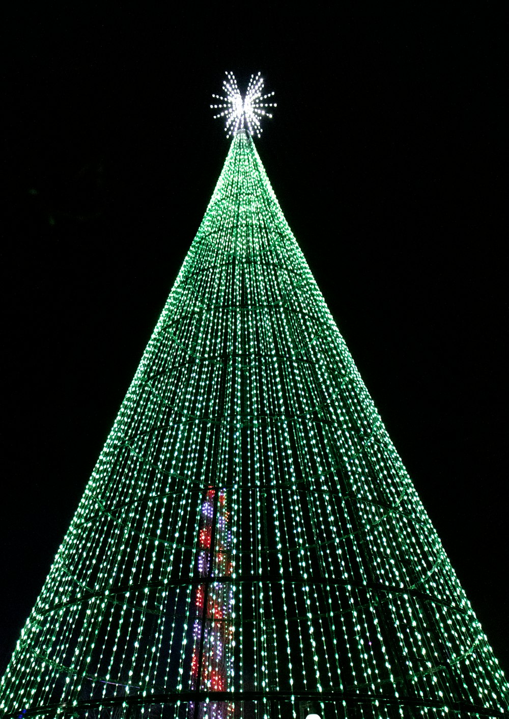 a large christmas tree with lights on it