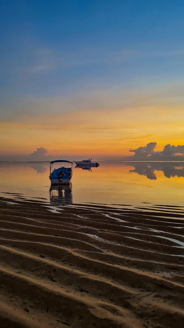 Fishing boat on the sand at sunrise in Sanur