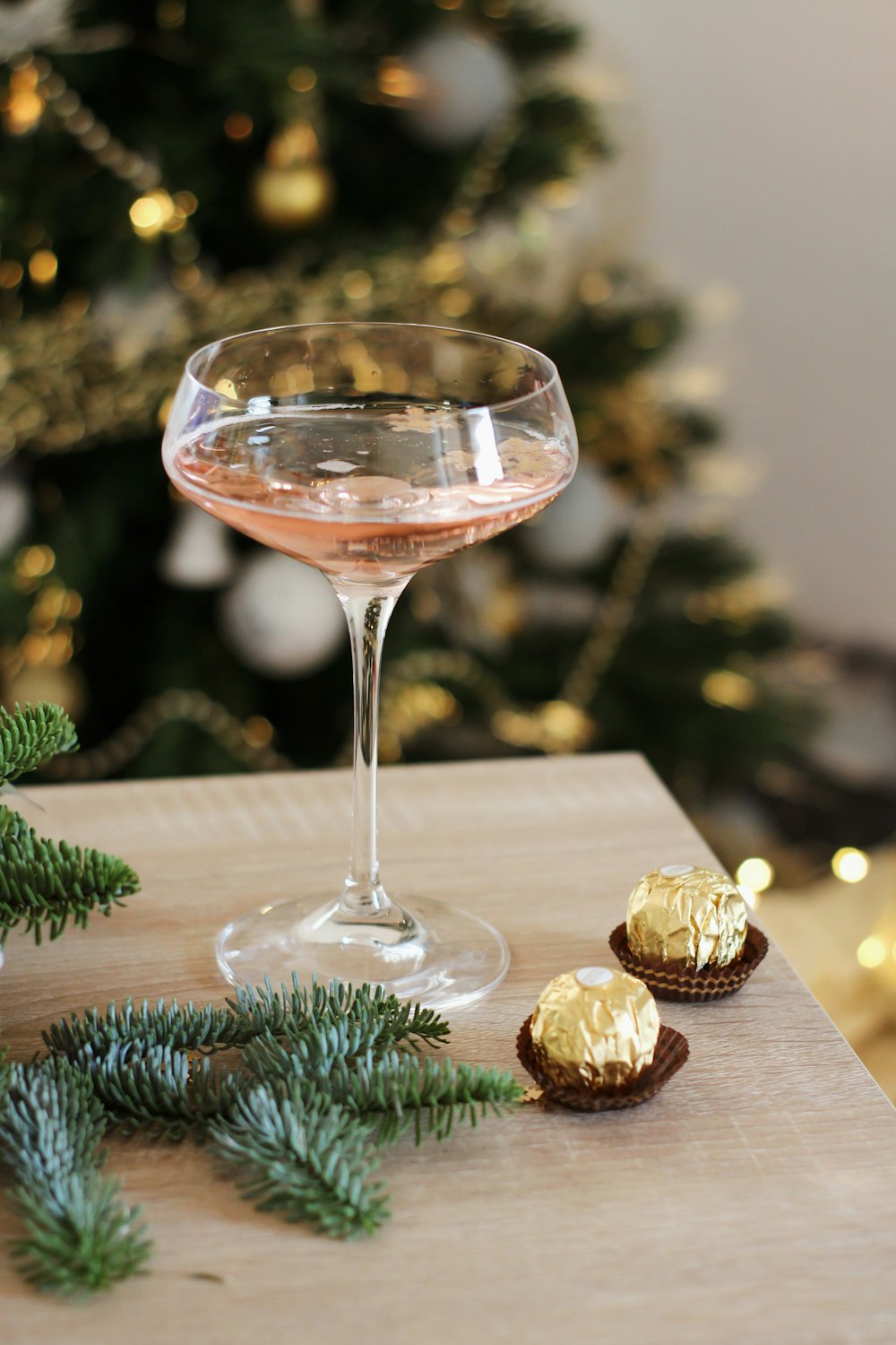 a glass of wine and some cookies on a table