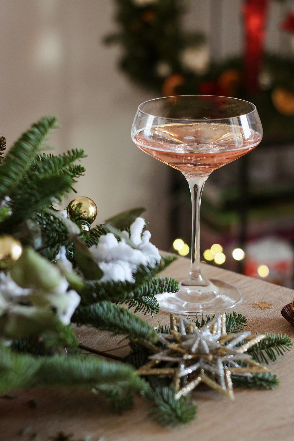 a glass of wine sitting on top of a wooden table