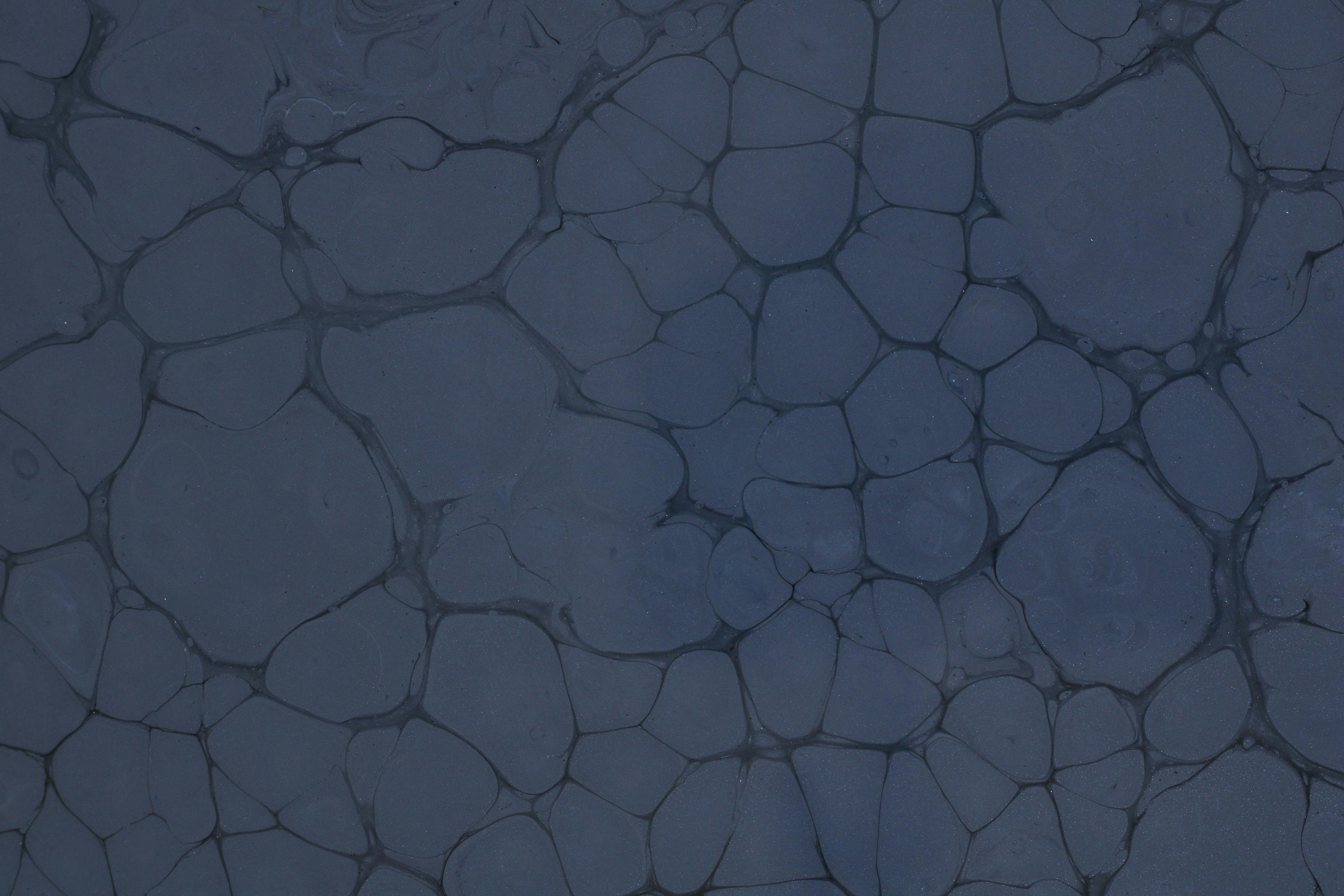 a black and white photo of rocks and water