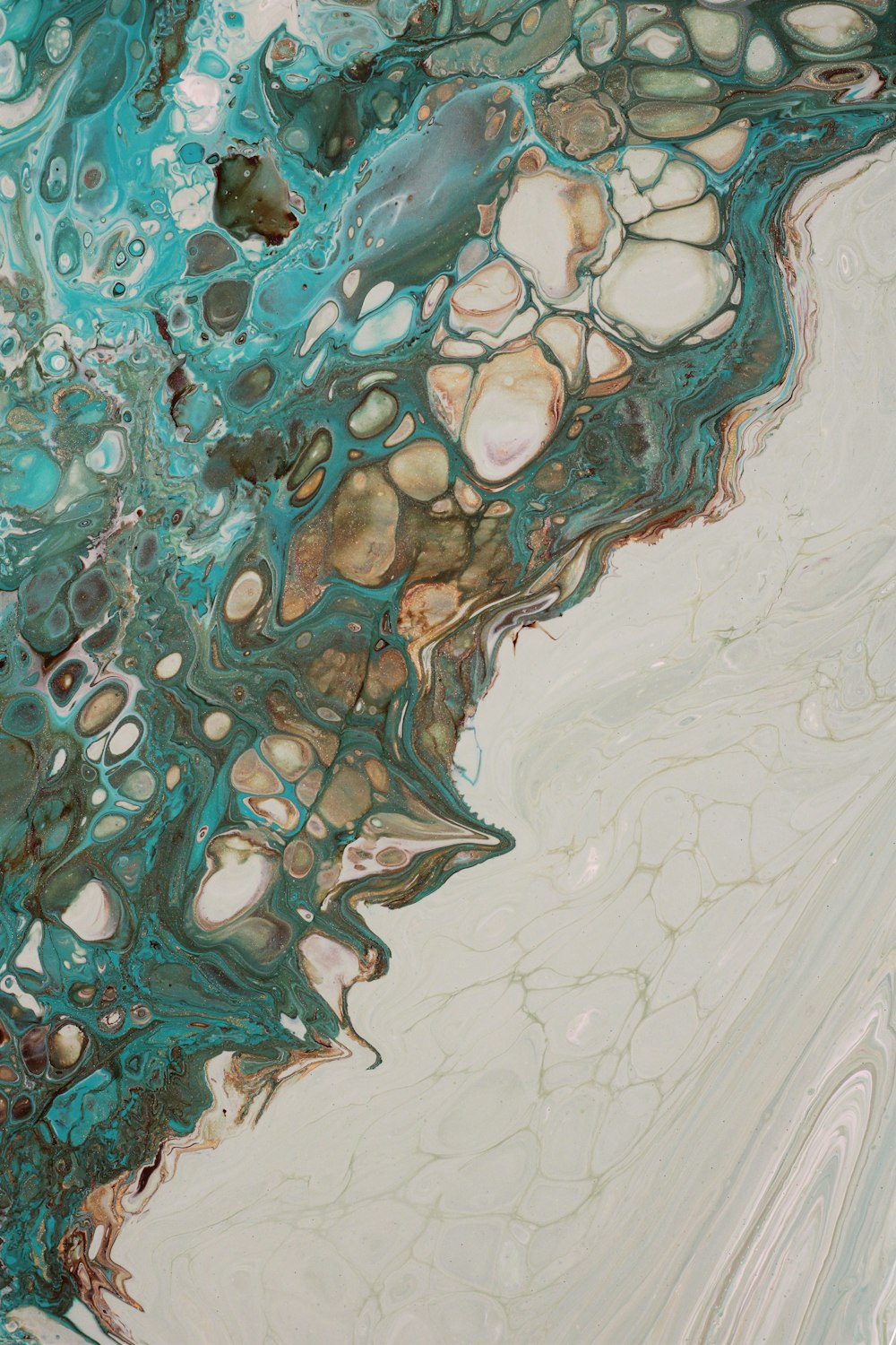 a close up of a blue and white fluid painting