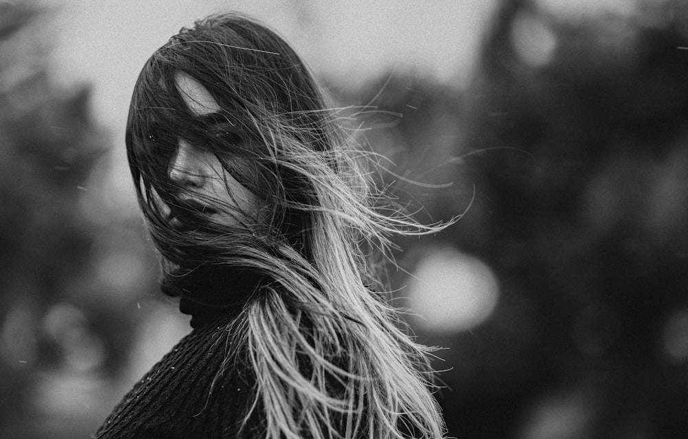 a black and white photo of a woman with long hair