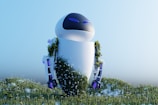 A futuristic robot standing in a field of flowers and grass, partially covered in greenery and small white blossoms. Its sleek, white design with blue accents contrasts with the natural environment.