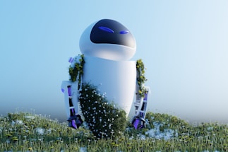 A futuristic robot standing in a field of flowers and grass, partially covered in greenery and small white blossoms. Its sleek, white design with blue accents contrasts with the natural environment.