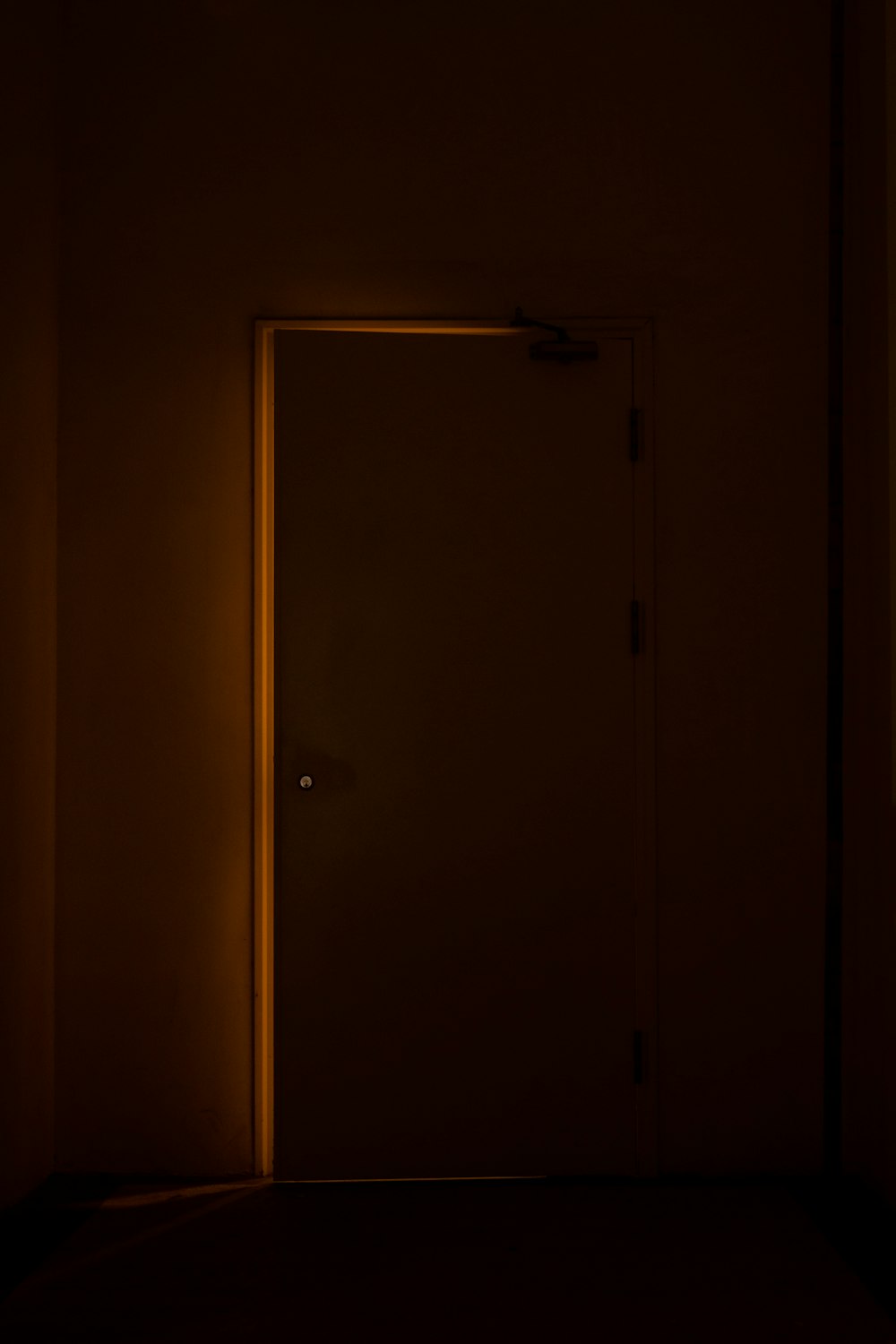 a door in a dark room with a light on