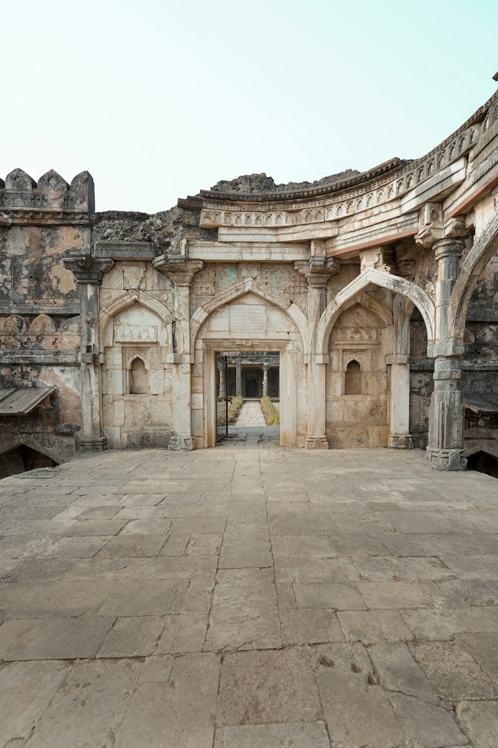 a large stone building with a doorway in the middle of it