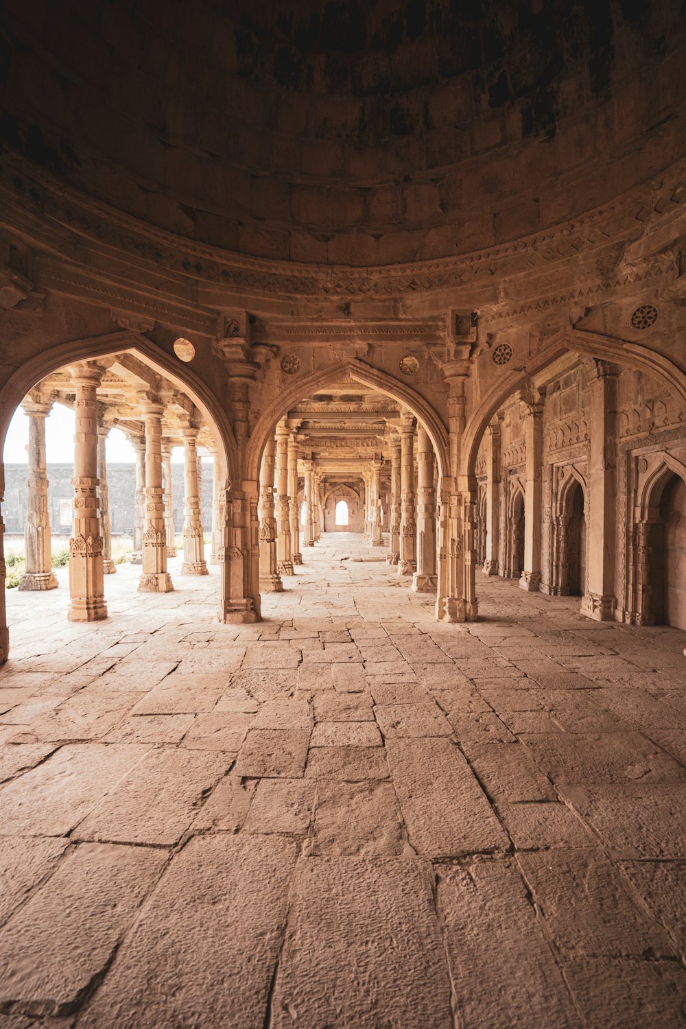 a large stone building with pillars and arches