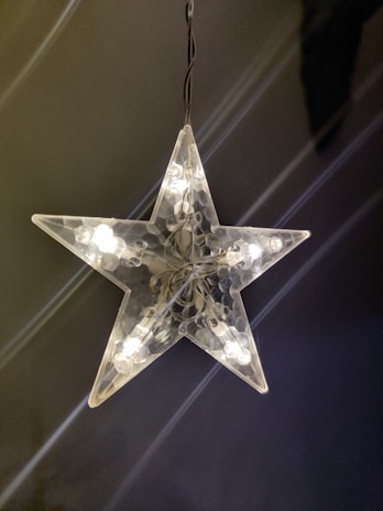Bright shooting star LED ornament illuminating a dark outdoor space