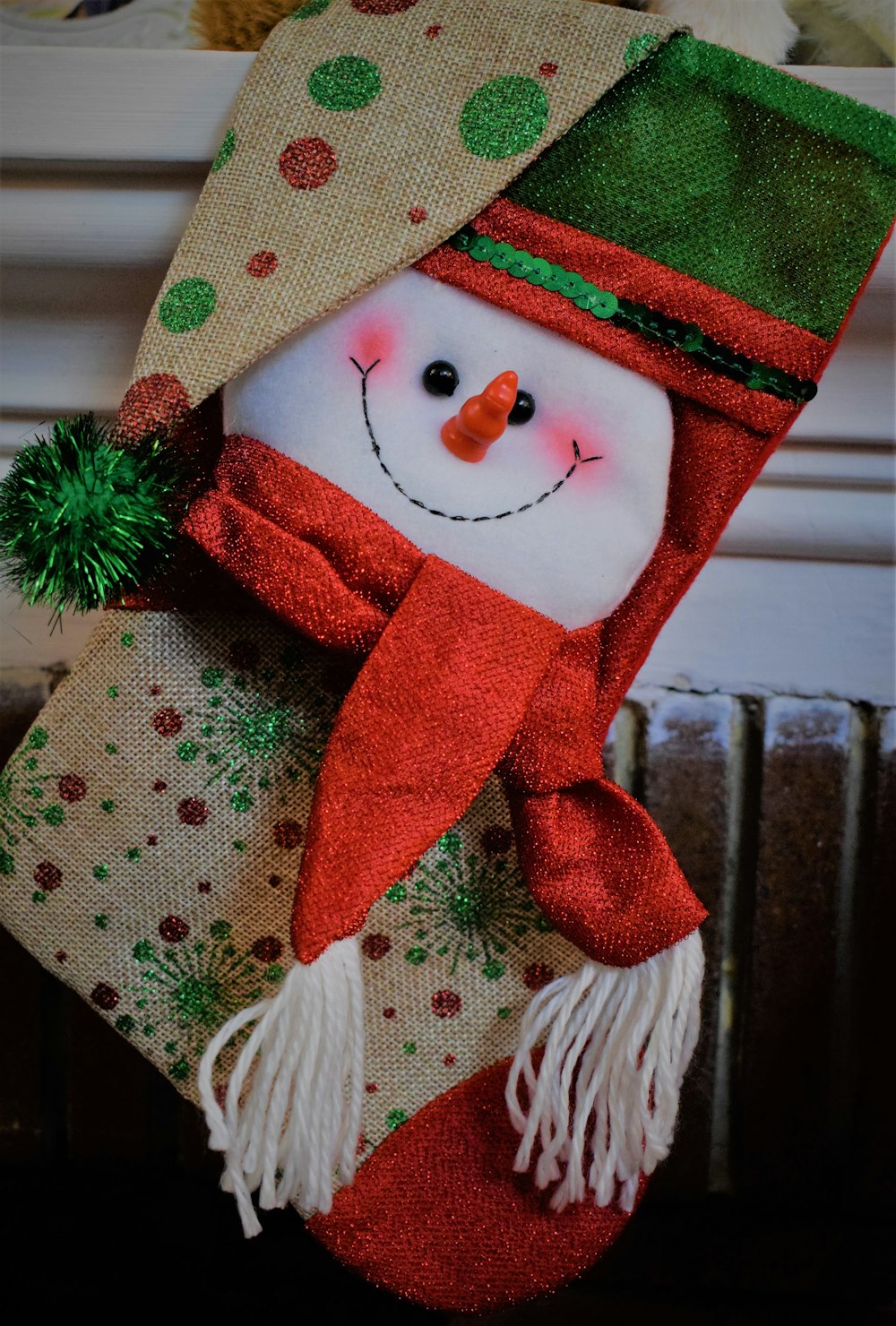 a christmas stocking with a snowman wearing a hat and scarf