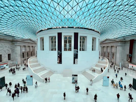 a group of people walking around inside of a building