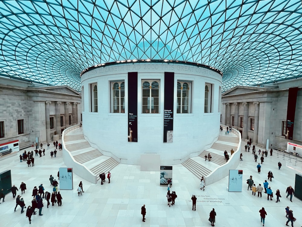 a group of people walking around inside of a building