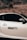 A sleek silver car is parked against a backdrop of dry, grassy hills. The car's door features a sticker that reads 'Boost Loading' with a progress bar below it, adding a playful touch.
