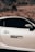 A sleek silver car is parked against a backdrop of dry, grassy hills. The car's door features a sticker that reads 'Boost Loading' with a progress bar below it, adding a playful touch.