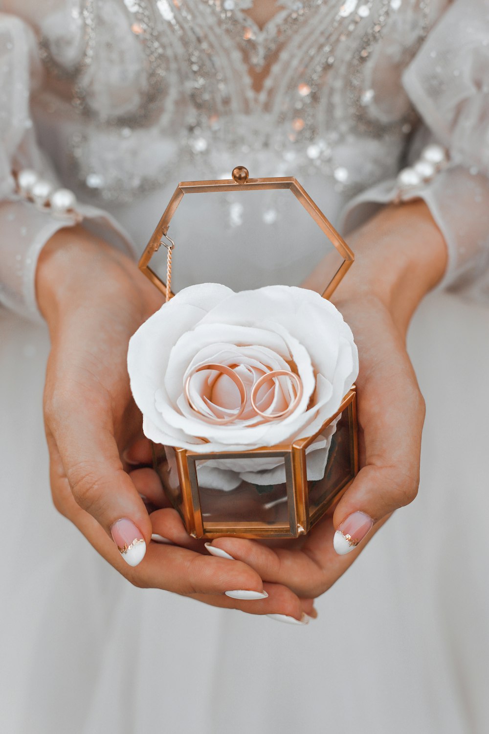 a close up of a person holding a ring box