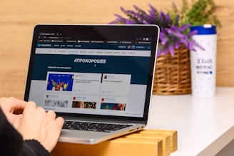 a person using a laptop computer on a desk