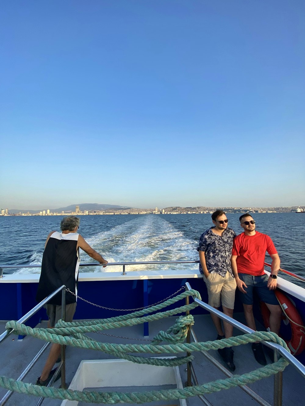 two men standing on a boat in the water