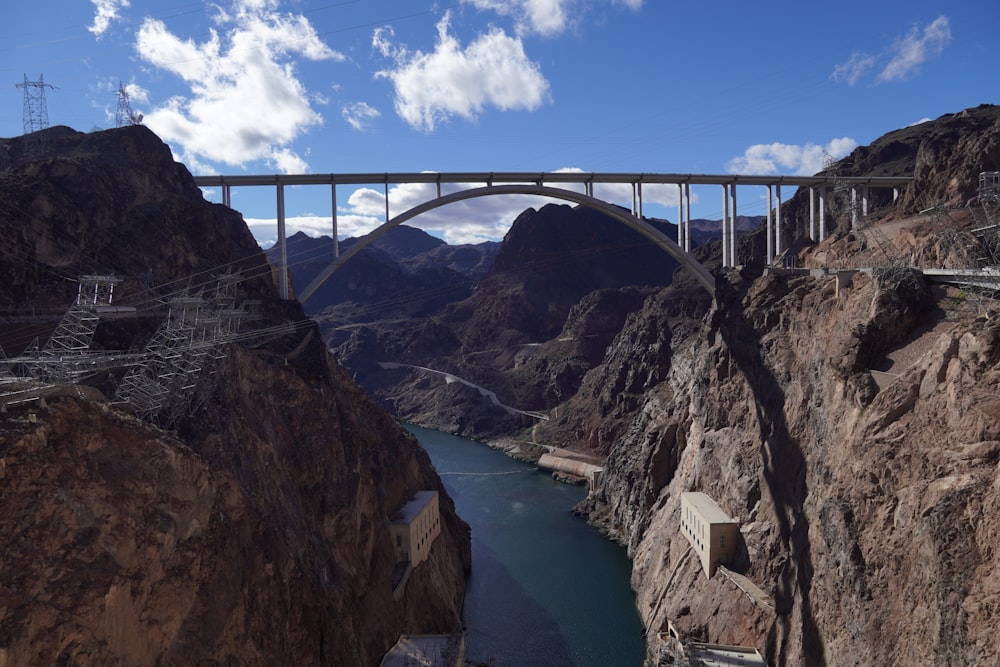 a bridge over a river in a canyon