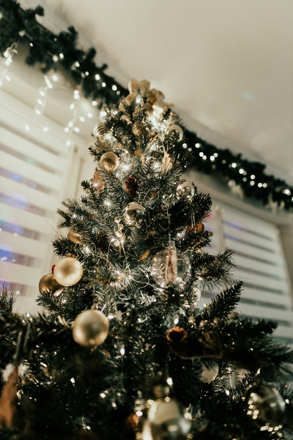 a small christmas tree is decorated with gold and silver ornaments
