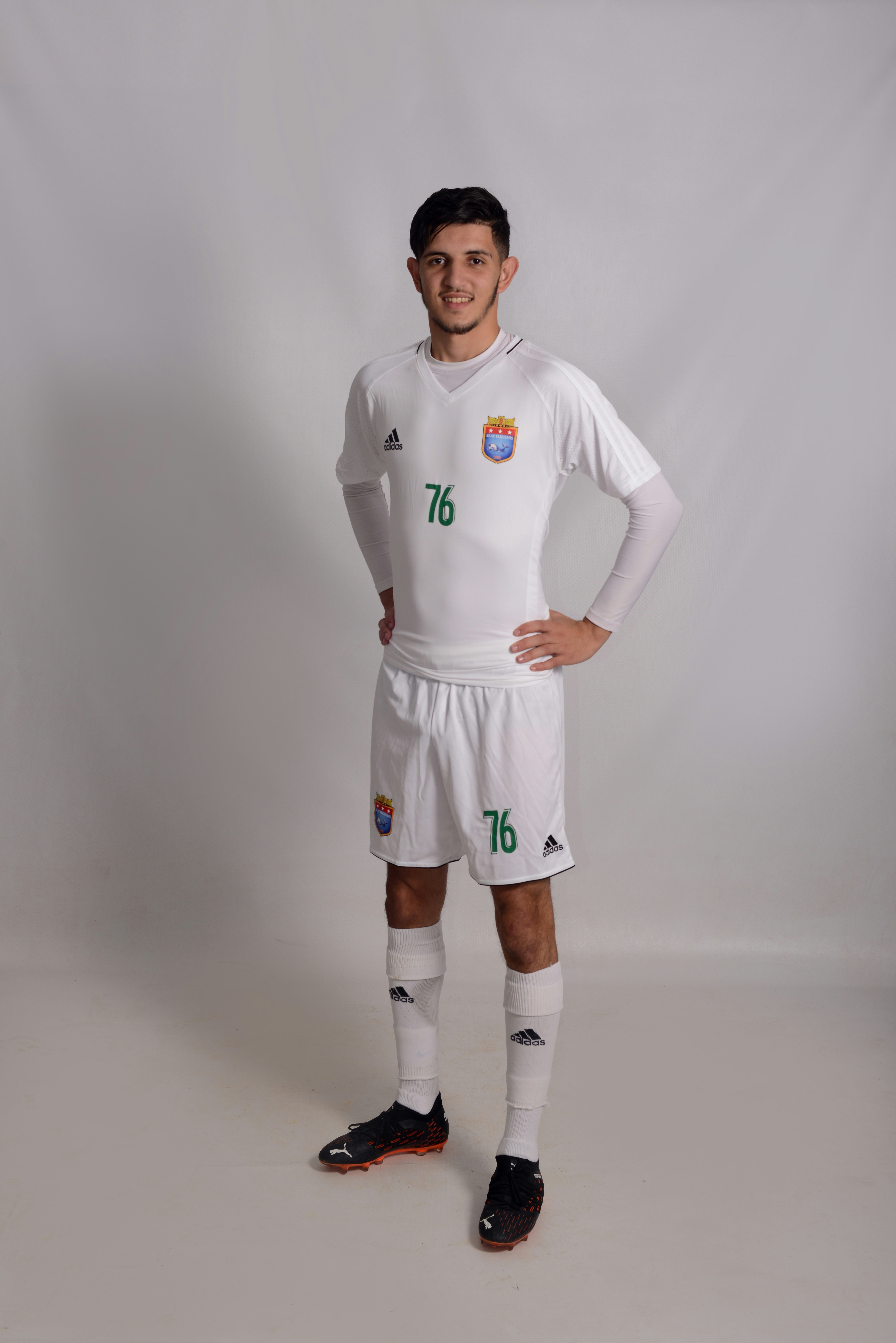 a man in a soccer uniform poses for a picture