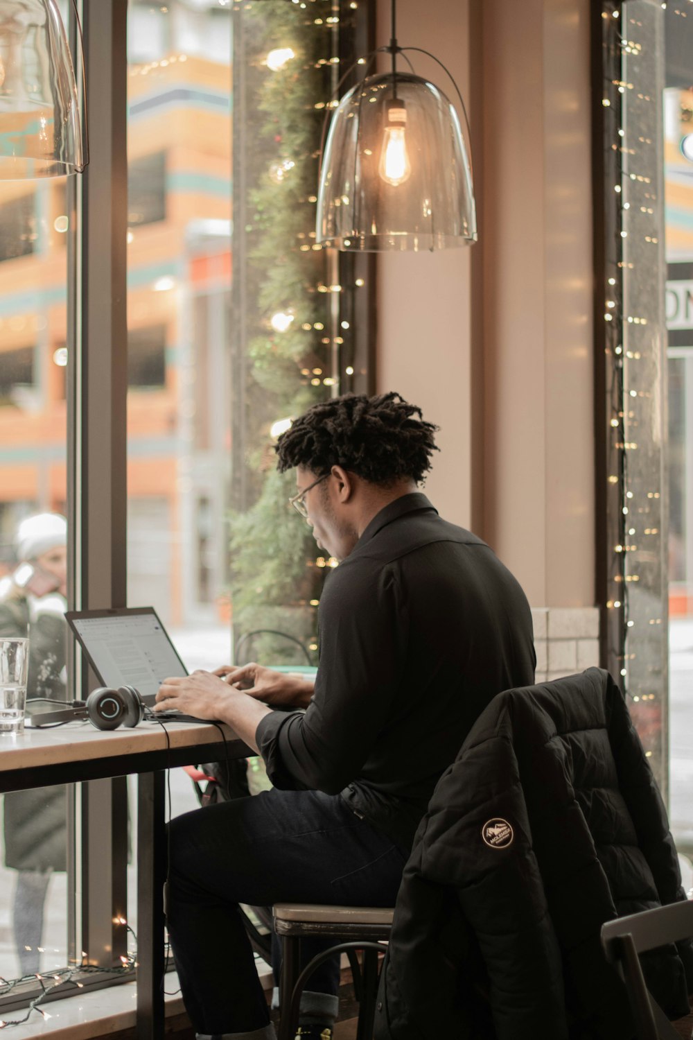 a man sitting at a table using a laptop computer