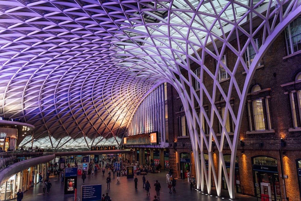 a train station with people walking around it