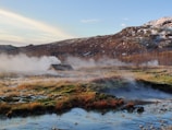 A scenic shot of a volcanic landscape with colorful geothermal areas.