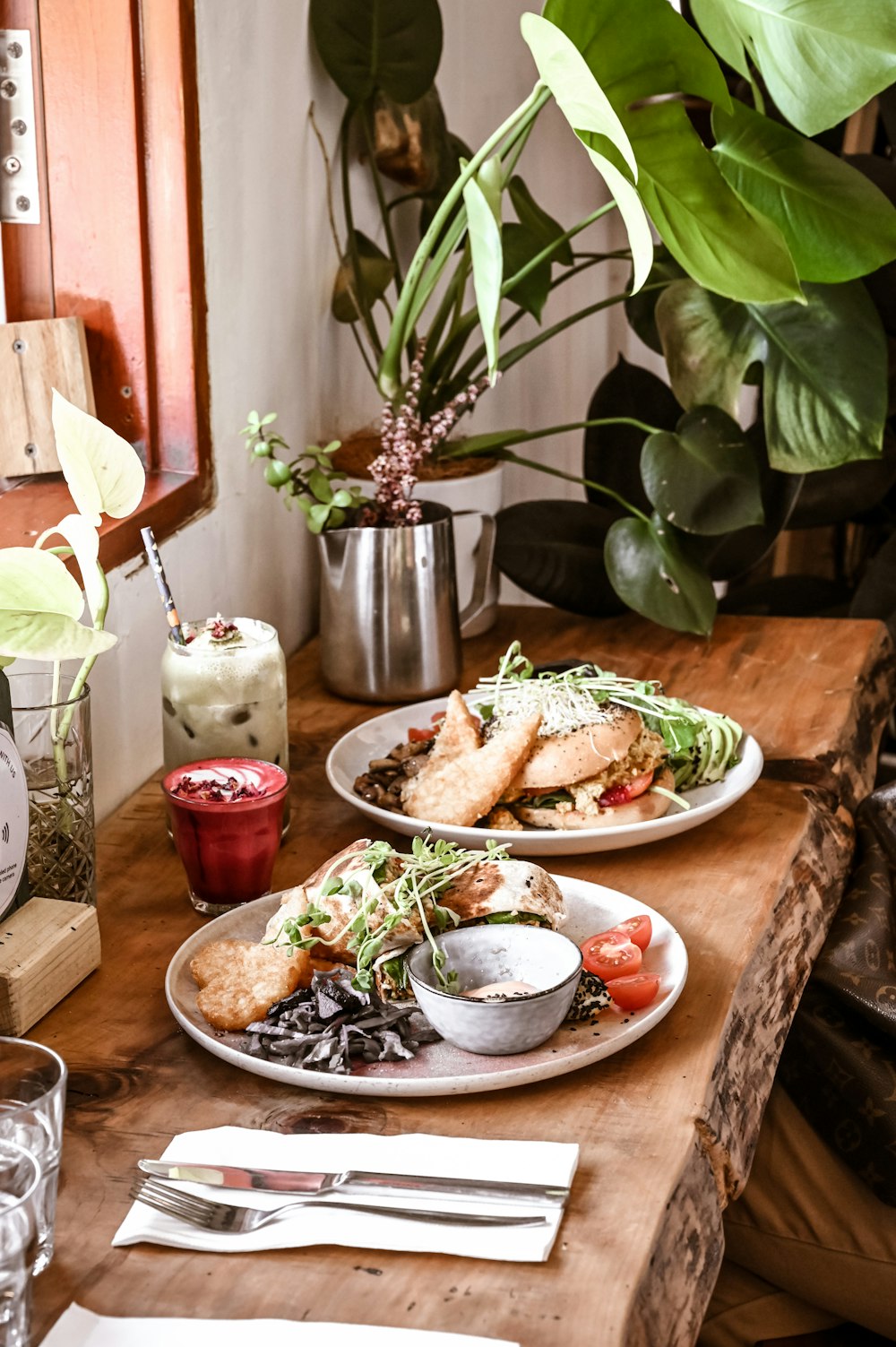 a wooden table topped with plates of food